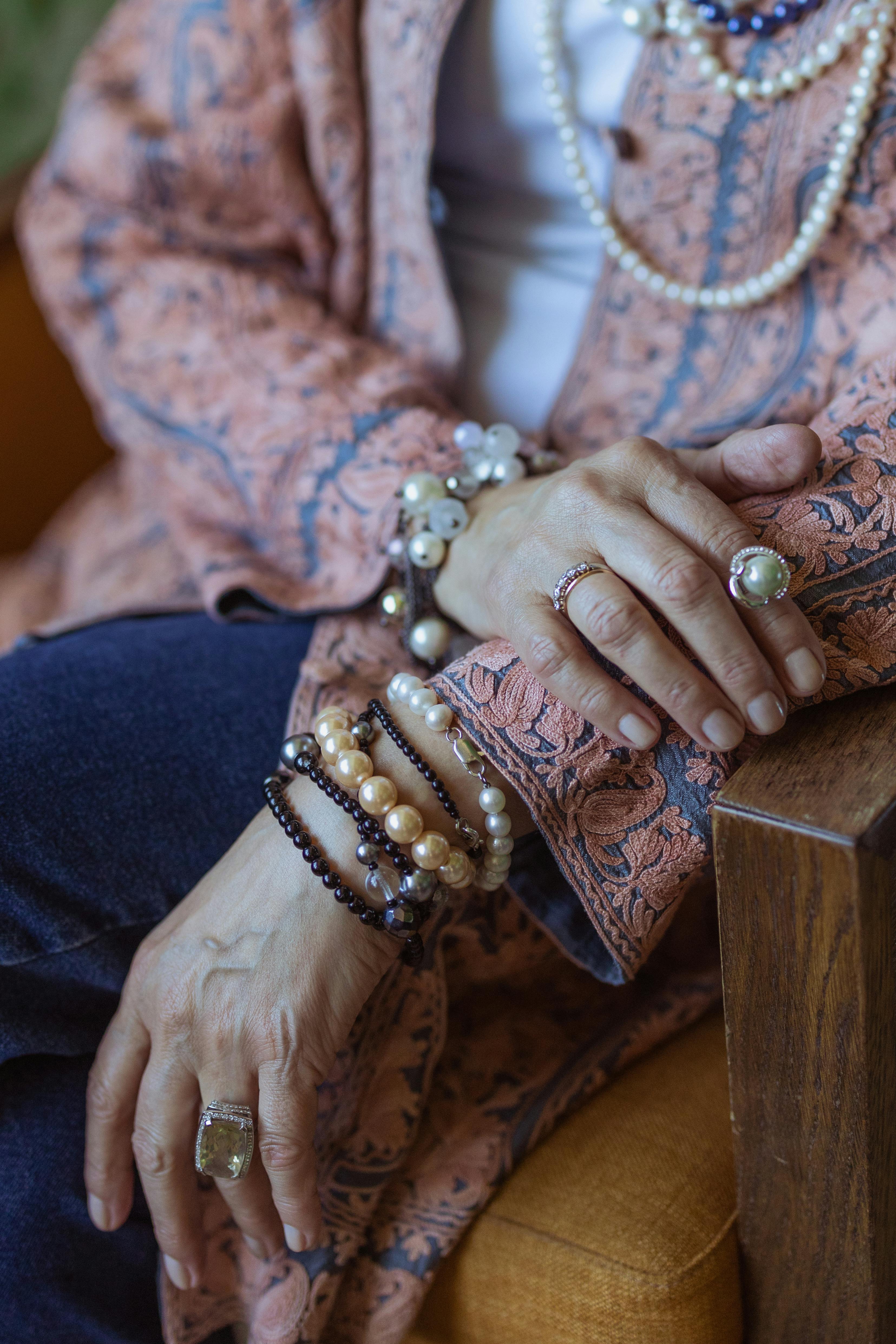 Close Up Of Stylish Hands Adorned With Elegant Bracelets And Rings, Highlighting Bohemian Fashion.